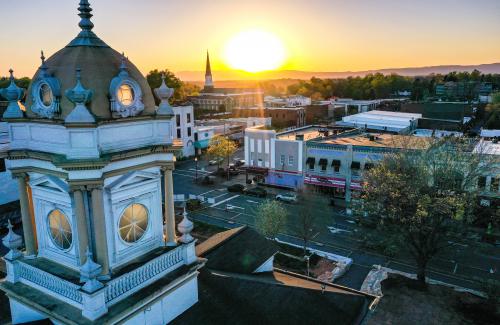 An aerial image of Downtown Morganton at sunset featuring the Historic Courthouse and local shops