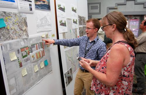 A Stantec staffer discusses ideas with a visitor.